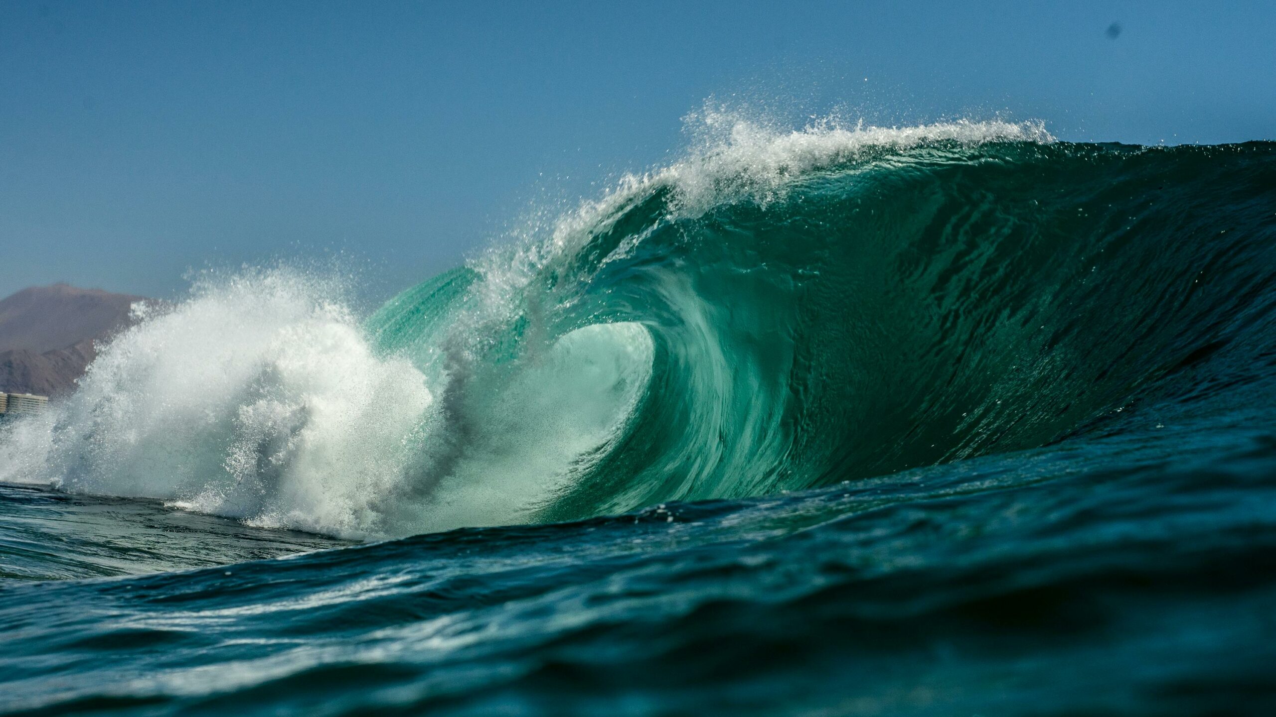 A stunning view of a powerful ocean wave crashing on the shores of Northern Chile.